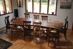 Walnut slab top dining table and 11 chairs